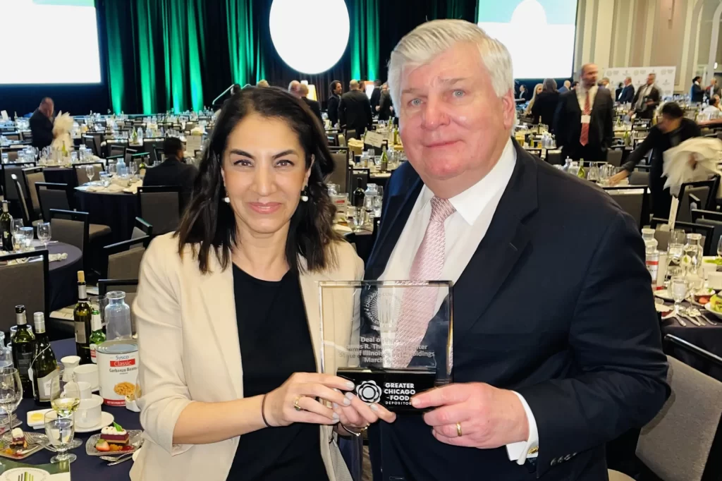 Ayse with Mike Reschke accepting the Real Estate Deal of the Year Award